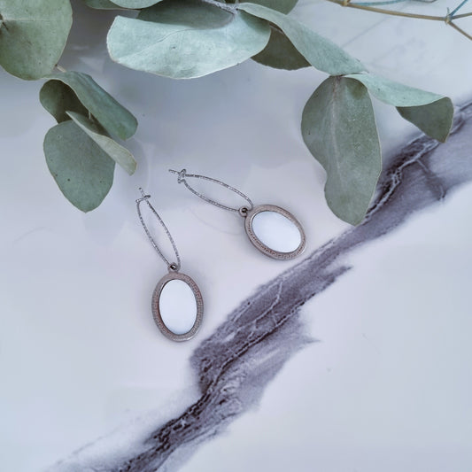 White and silver earrings