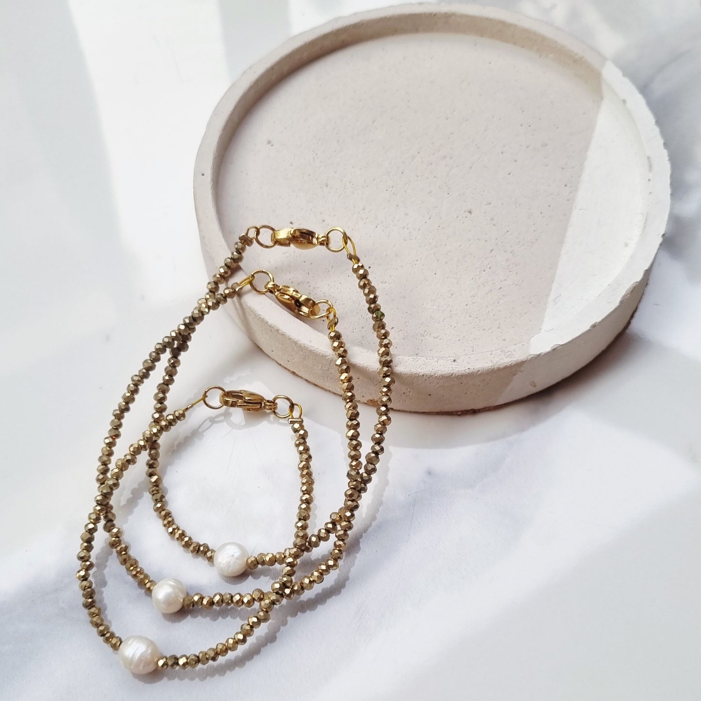 Gold and pearl bracelets