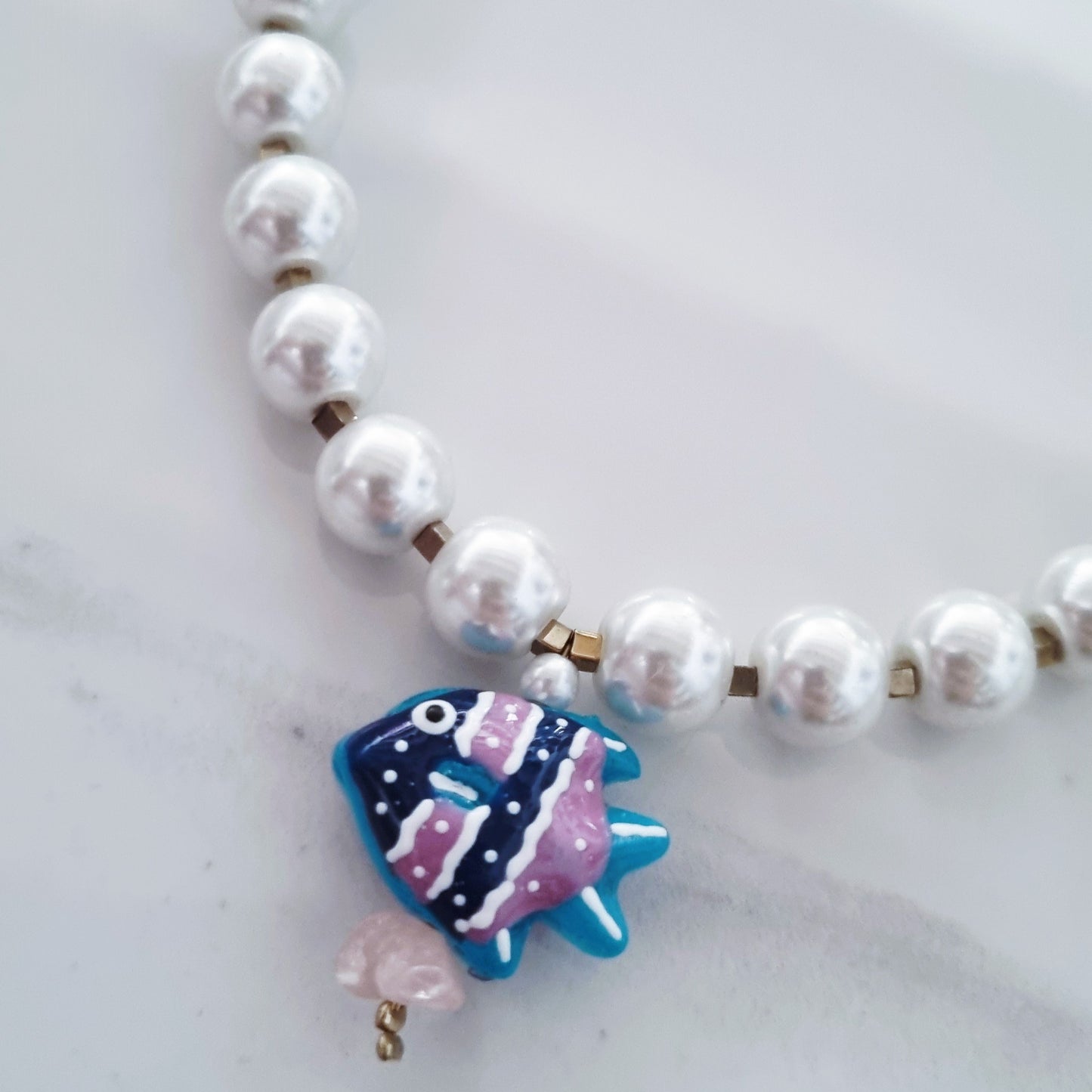 Pearls and blue fish