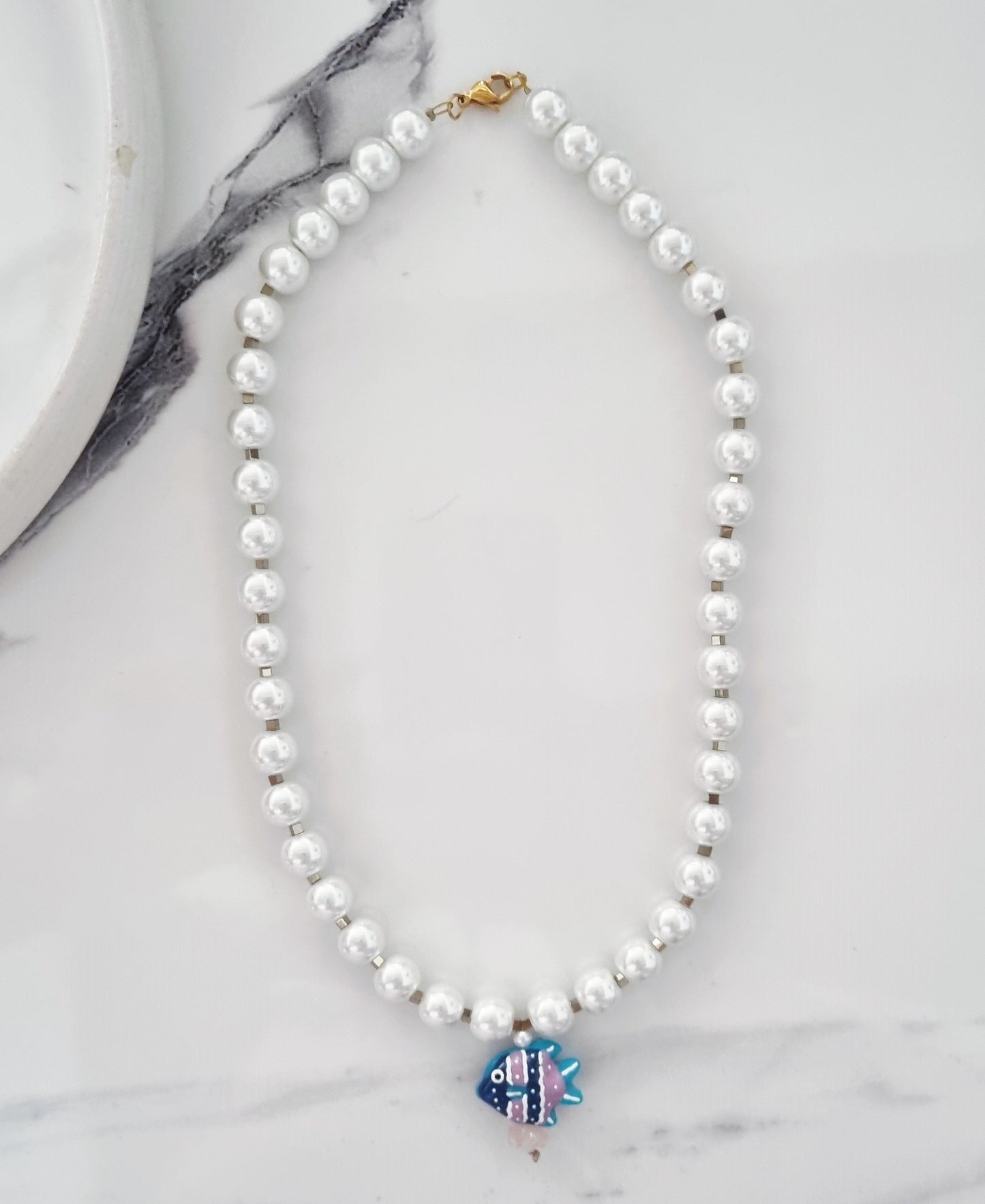 Pearls and blue fish