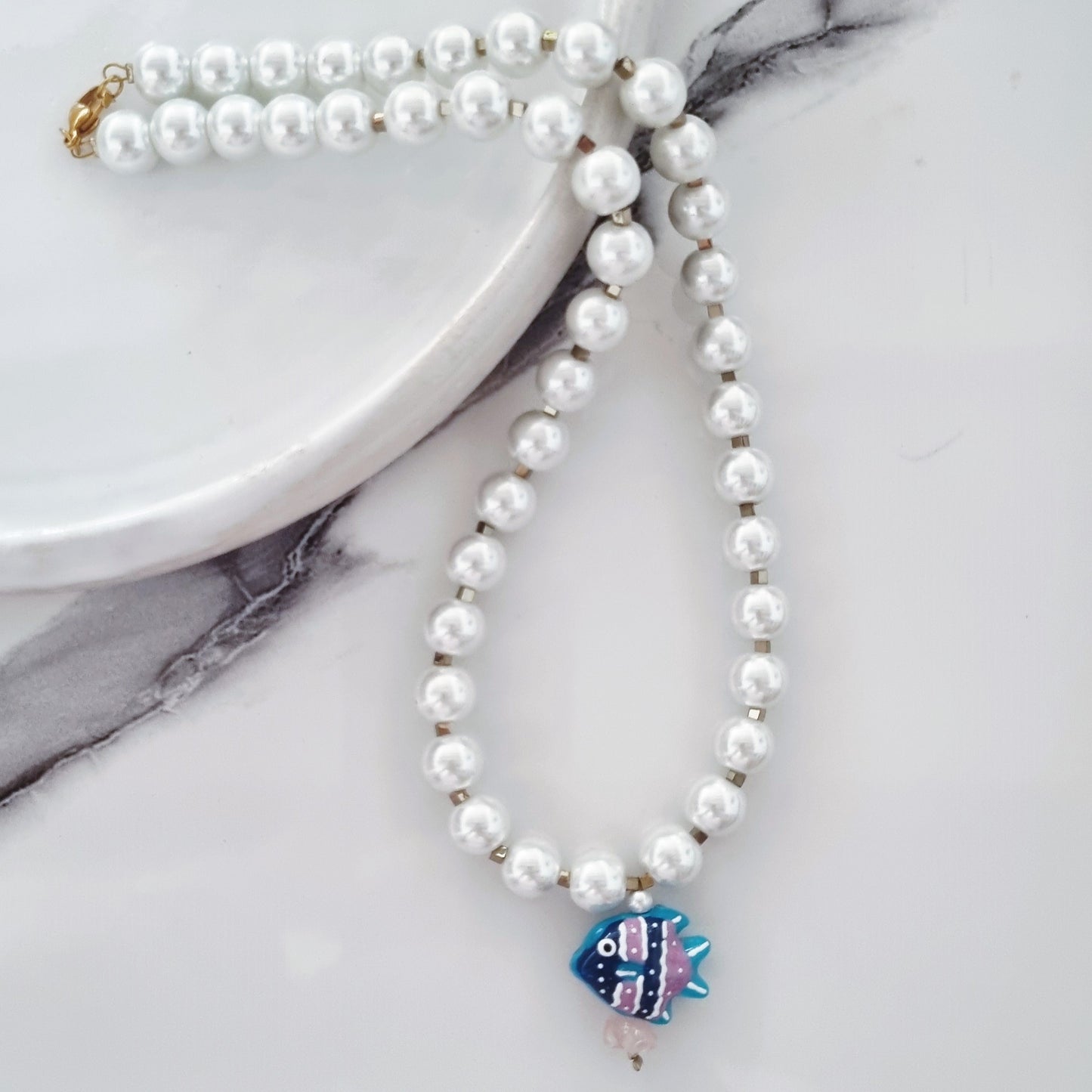 Pearls and blue fish