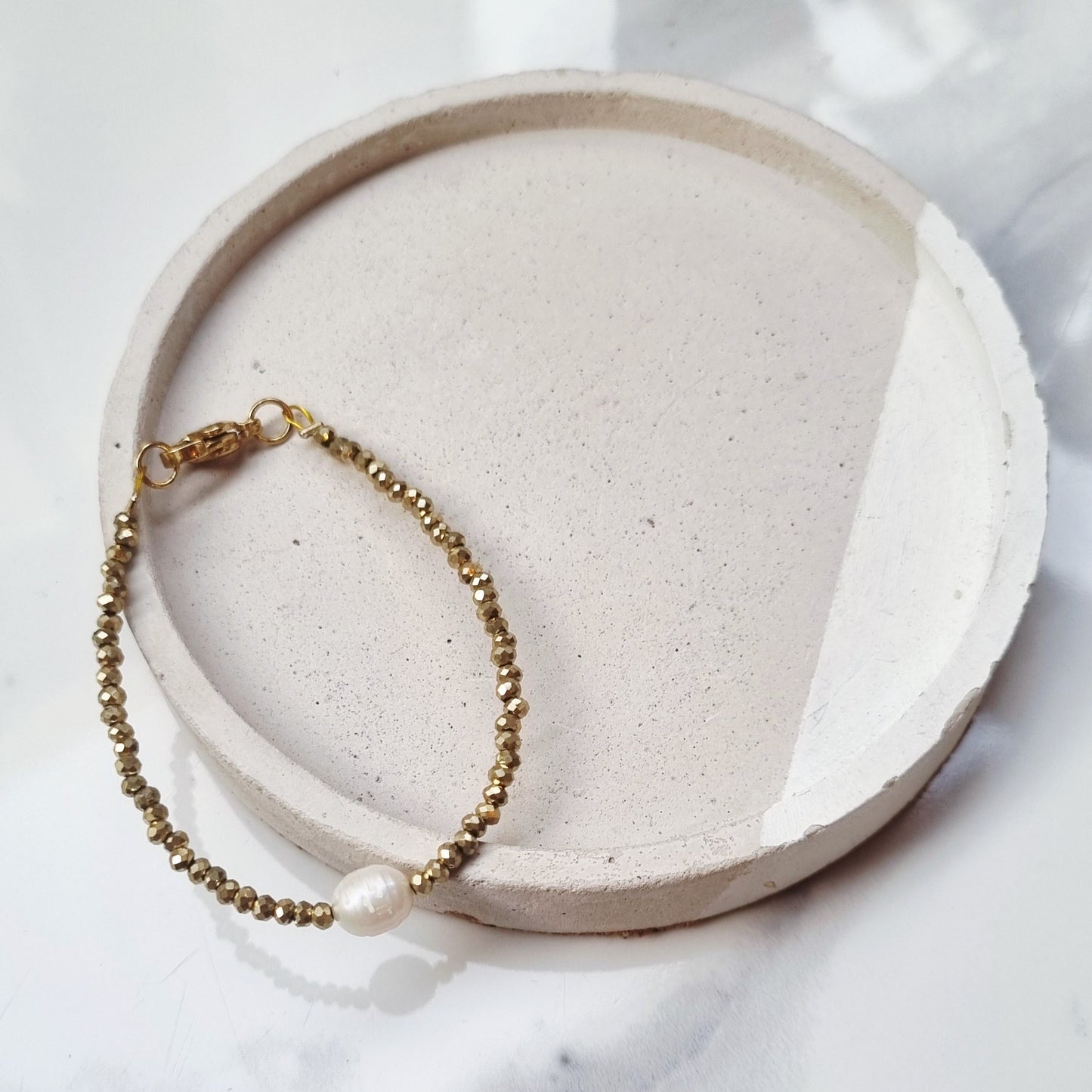 Gold and pearl bracelets