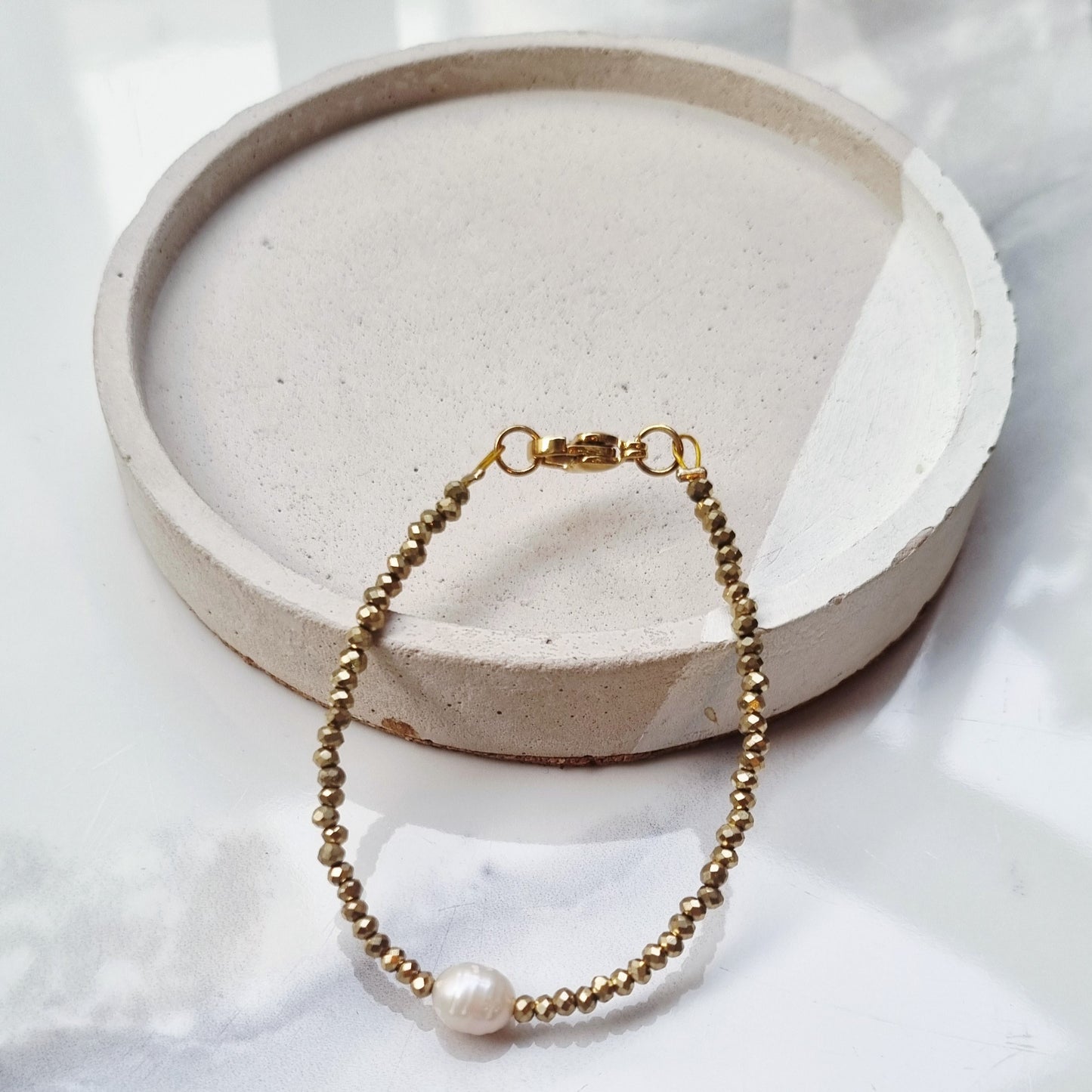 Gold and pearl bracelets